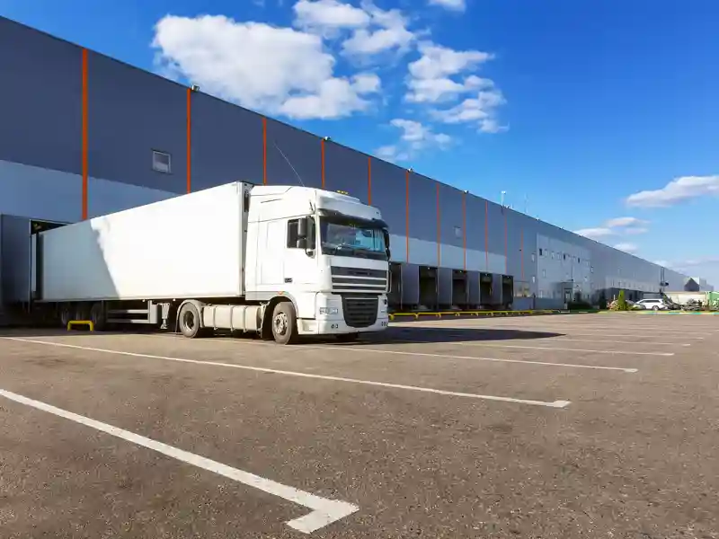 Semi-truck backed into a loading dock.