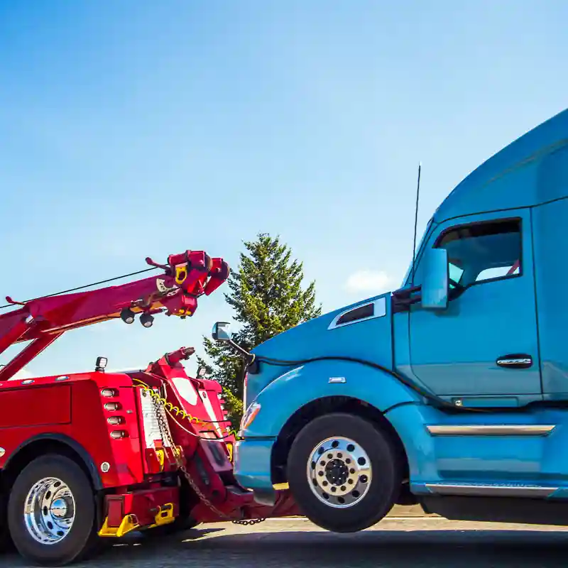 Tow truck towing 18 wheeler.