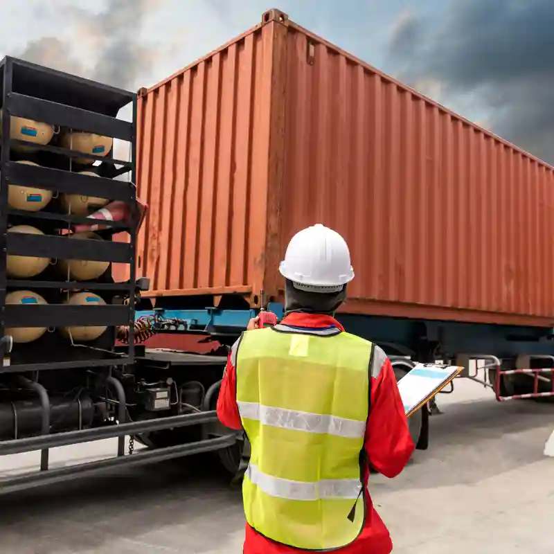 Worker inspecting a tractor trailer load.