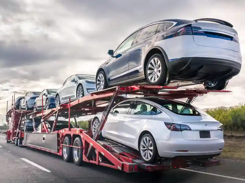 Side view of a car hauler full of inventory.